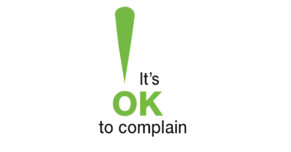 A logo with a green exclamation point and black text. Text reads: "It's OK to complain".