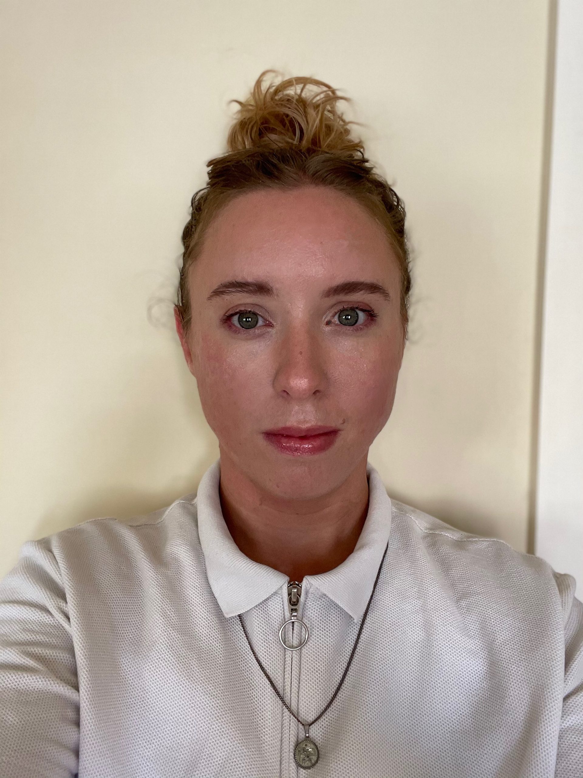 Headshot Elyse Cox. a person looking at the camera directly wearing a white jacket with brown hair